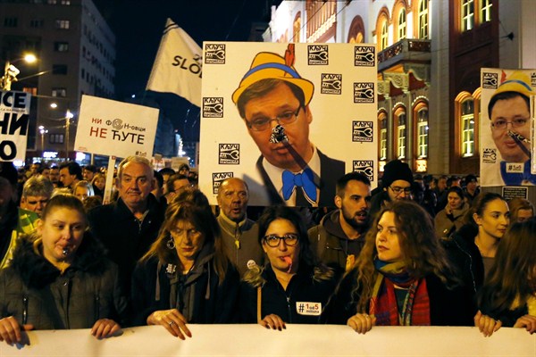 Protesters hold a poster of Serbian President Aleksandar Vucic with a Pinocchio nose, Belgrade, Serbia, March 2, 2019 (AP photo by Darko Vojinovic).