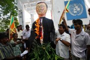 Sri Lankan protesters wave flags and burn an effigy of U.N. Secretary-General Ban Ki-moon outside the U.N. office in Colombo, Sri Lanka, July 6, 2010 (AP photo by Eranga Jayawardena).