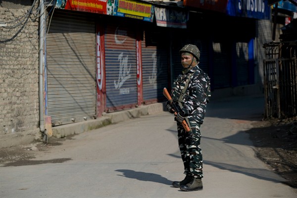 An Indian paramilitary soldier stands guard outside a closed market in Srinagar, Indian-controlled Kashmir, Feb. 28, 2019 (AP photo by Dar Yasin).