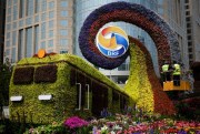 Workers install flowers on a decoration promoting the upcoming Belt and Road Forum in Beijing, April 23, 2019 (AP photo by Andy Wong).