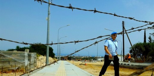 A U.N peacekeeper walks near a checkpoint intended to link Cyprus’ breakaway Turkish Cypriot north and internationally recognized south, Dherynia, April 27, 2017 (AP photo by Petros Karadjias).