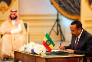 Ethiopian Prime Minister Abiy Ahmed, right, signs a peace accord with Eritrea as Saudi Crown Prince Mohammed bin Salman looks on, Jeddah, Saudi Arabia, Sept. 16, 2018 (Saudi Press Agency photo via AP Images).