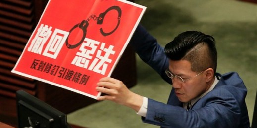 Pro-democracy lawmaker Gary Fan displays a sign reading “Withdraw bad law” to protest the extradition law during a Legislative Council session, Hong Kong, April 3, 2019 (AP photo by Vincent Yu).