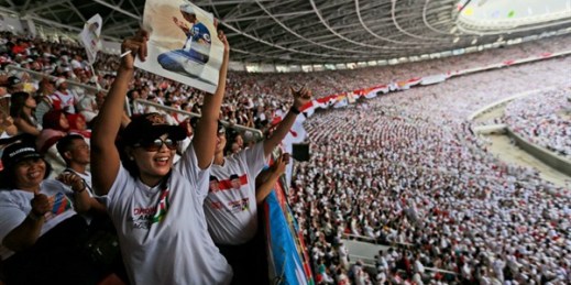 Indonesian women cheer during a campaign rally for Indonesian President Joko Widodo at a stadium in Jakarta, April 13, 2019 (AP photo by Dita Alangkara).