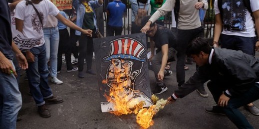 Filipino students burn a caricature depicting President Rodrigo Duterte during a protest in front of the gates of the Malacanang presidential compound, Manila, Philippines, Oct. 19, 2017 (AP photo by Aaron Favila).