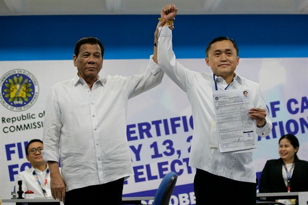 Philippine President Rodrigo Duterte, left, with his aide, Christopher “Bong” Go, who is a senatorial candidate in next month’s midterm elections, in Manila, Philippines, Oct. 15, 2018 (AP photo by Aaron Favila).
