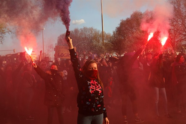 Women hold flares during a march for International Women’s Day in Madrid, Spain, March 8, 2019 (AP photo by Bernat Armangue).