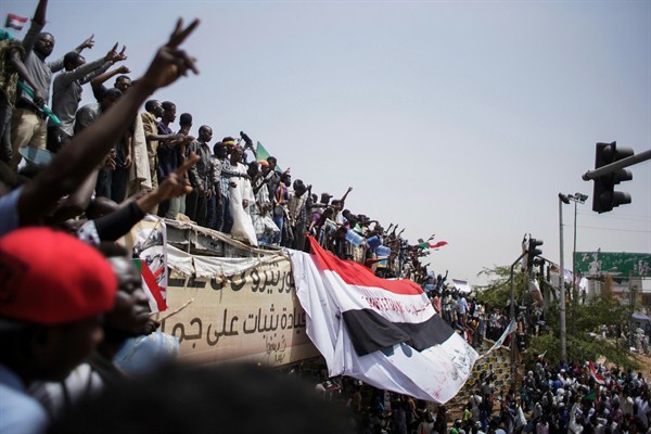 Sudanese demonstrators gather outside the Defense Ministry a day after the military took power and arrested President Omar al-Bashir, Khartoum, Sudan, April 12, 2019 (Photo by Ala Kheir for dpa via AP Images).