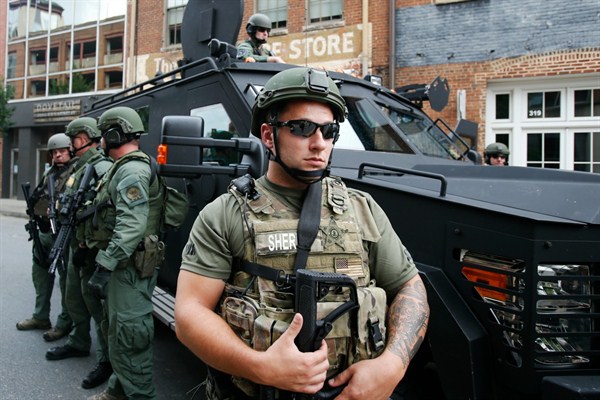 Members of a SWAT team keep an eye on demonstrators marking the one-year anniversary of the Unite the Right rally in Charlottesville, Va., Aug. 12, 2018 (AP photo by Steve Helber).