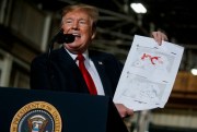 President Donald Trump holds up a chart documenting land lost by the Islamic State in Iraq and Syria as he delivers remarks in Lima, Ohio, March 20, 2019 (AP photo by Evan Vucci).
