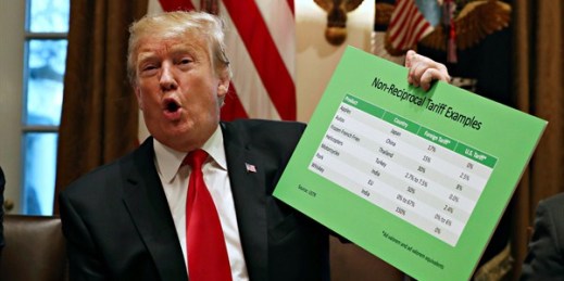 President Donald Trump holds up examples of foreign tariffs in the Cabinet Room of the White House, Washington, Jan. 24, 2019 (AP photo by Jacquelyn Martin).