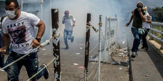 Demonstrators on the Simon Bolivar international bridge during a clash with the Venezuelan National Guard, in Cucuta, Colombia, Feb. 23, 2019 (Photo by Benjamin Rojas for dpa via AP Images).