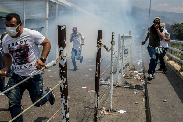 Demonstrators on the Simon Bolivar international bridge during a clash with the Venezuelan National Guard, in Cucuta, Colombia, Feb. 23, 2019 (Photo by Benjamin Rojas for dpa via AP Images).