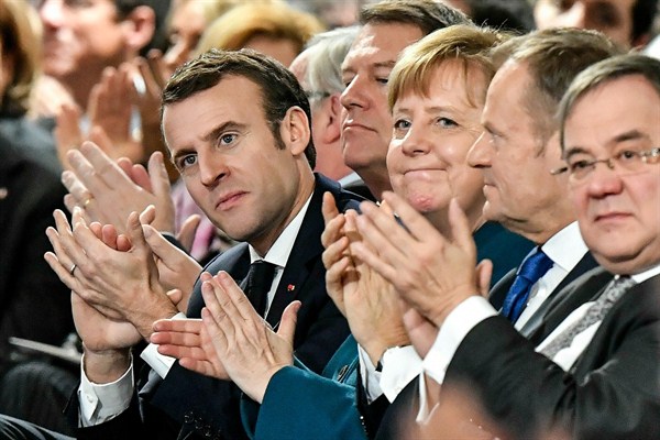 French President Emmanuel Macron, German Chancellor Angela Merkel and European Council President Donald Tusk applaud after the signing of a new Germany-France friendship treaty, Aachen, Germany, Jan. 22, 2019 (AP photo by Martin Meissner).