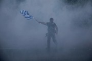 A protester amid smoke from tear gas during clashes at the northern Greek city of Thessaloniki, Sept. 8, 2018 (AP photo by Dimitris Tosidis).