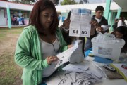 An electoral worker shows a ballot marked “yes” during a referendum concerning a border dispute with Belize, in Guatemala City, April 15, 2018 (AP photo by Moises Castillo).