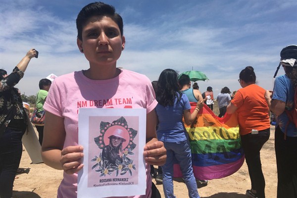 Gabriela Hernandez, executive director of the nonprofit New Mexico Dream Team, holds up an image of Roxana Hernandez, a Honduran transgender woman who died in U.S. custody, Albuquerque, N.M., June 6, 2018 (AP photo by Mary Hudetz).