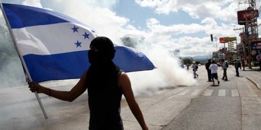 A demonstrator waves a Honduran flag during a protest against the government of President Juan Orlando Hernandez in Tegucigalpa, Honduras, Jan. 27, 2019 (AP photo by Fernando Antonio).