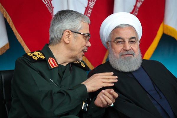 Iranian President Hassan Rouhani, right, listens to Chief of the General Staff of the Armed Forces Gen. Mohammad Hossein Bagheri during an army parade just outside Tehran, Iran, April 18, 2019 (Office of the Iranian Presidency photo via AP Images).