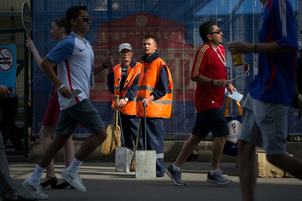 Municipal workers at Luzhniki Stadium in Moscow, Russia, June 26, 2018 (AP photo by Alexander Zemlianichenko). The role of immigrants in the labor force is an unresolved question of Russia's immigration policy.