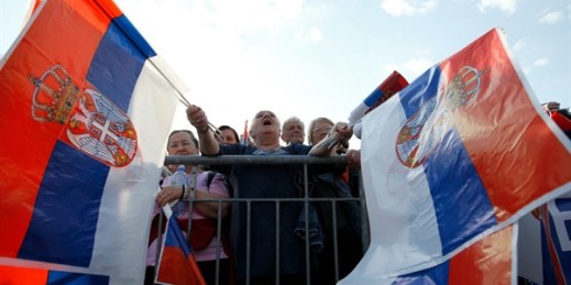 A supporter of Serbian President Aleksandar Vucic waves Serbian flags and shouts slogans during a rally to counter months of anti-government protests in Belgrade, Serbia, April 19, 2019 (AP photo by Darko Vojinovic).