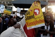 A man holds a poster reading “We stand against xenophobia” during a march in Johannesburg, South Africa, April 23, 2015 (AP photo by Themba Hadebe).