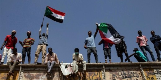 Sudanese protesters wave national flags at the sit-in outside the military headquarters, in Khartoum, Sudan, May 2, 2019 (AP photo by Salih Basheer).