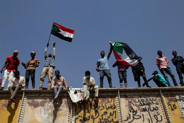 Sudanese protesters wave national flags at the sit-in outside the military headquarters, in Khartoum, Sudan, May 2, 2019 (AP photo by Salih Basheer).