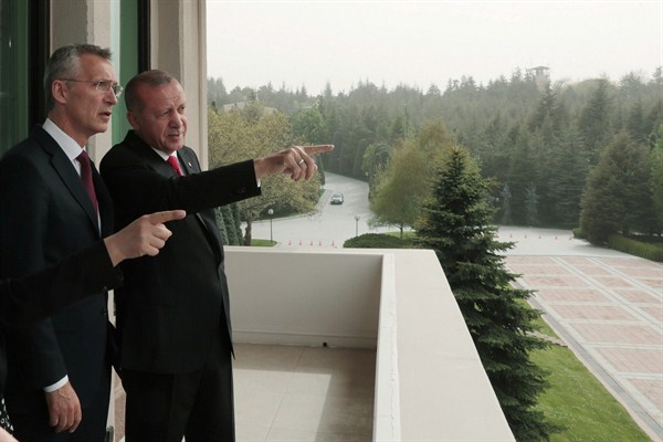 Turkish President Recep Tayyip Erdogan, right, points toward the city center as he speaks with NATO Secretary-General Jens Stoltenberg during a meeting in Ankara, May 6, 2019 (Presidential Press Service via AP Images).