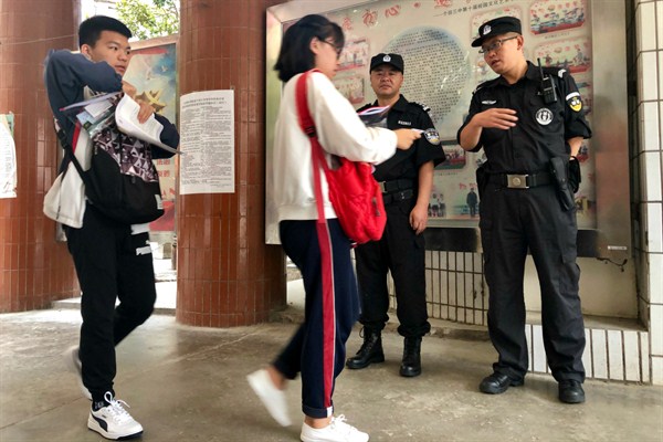 School security guards check students’ national ID cards and testing ID cards to allow admittance to the gaokao, China’s college entrance exam, in Gejiu, China, June 7, 2019 (Photo by Matthew Chitwood)