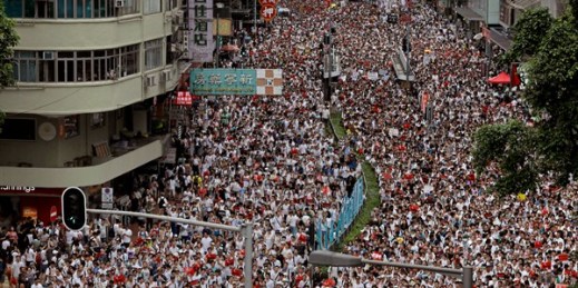 Protesters march along a downtown street against the proposed amendments to an extradition law in Hong Kong, June 9, 2019 (AP photo by Vincent Yu).