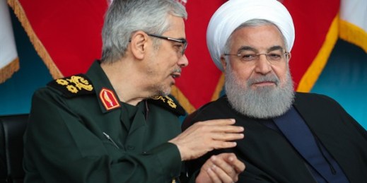 Iranian President Hassan Rouhani, right, listens to Chief of the General Staff of the Armed Forces Gen. Mohammad Hossein Bagheri during an army parade just outside Tehran, Iran, April 18, 2019 (Office of the Iranian Presidency photo via AP Images).