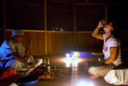 An Italian tourist drinks ayahuasca, monitored by a shaman, during a session in Nuevo Egipto, a remote village in the Peruvian Amazon, May 6, 2018 (AP photo by Martin Mejia).