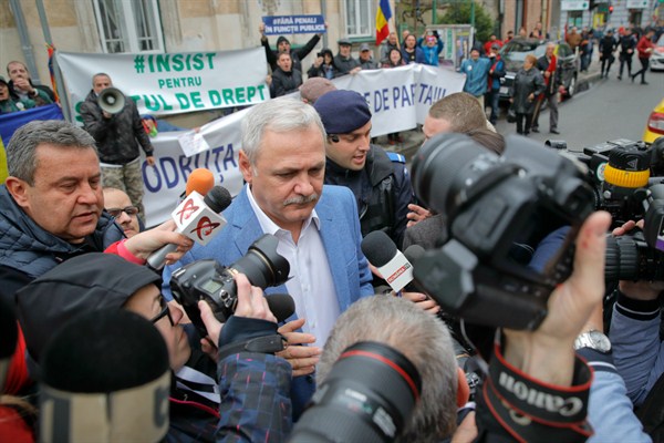 Liviu Dragnea, the former leader of Romania’s ruling Social Democratic Party, center, arrives escorted by police officers for a court hearing in Bucharest, Romania, April 15, 2019 (AP photo by Vadim Ghirda).