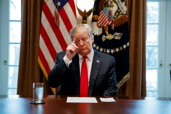 President Donald Trump looks at his notes before speaking during an event on human trafficking in the Cabinet Room of the White House, in Washington, Feb. 1, 2019 (AP photo by Evan Vucci). Critics say under Trump trafficking protections have weakened.