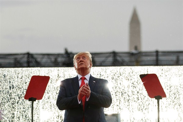 President Donald Trump looks up during military flyovers at an Independence Day celebration in front of the Lincoln Memorial, in Washington, July 4, 2019 (AP photo by Carolyn Kaster).
