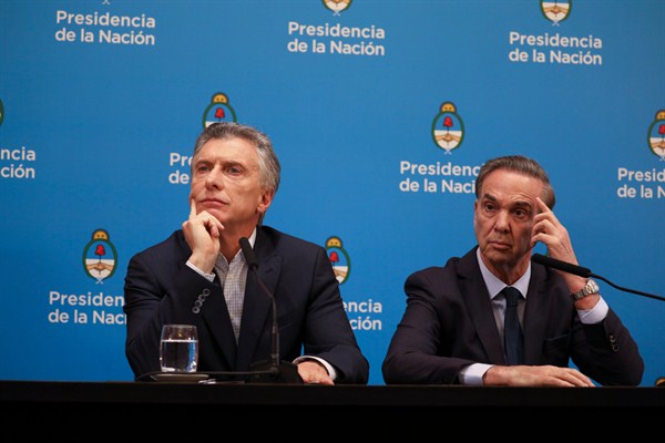 Argentine President Mauricio Macri gives a press conference alongside his running mate, Miguel Angel Pichetto, the day after primary elections in Buenos Aires, Argentina, Aug. 12, 2019 (AP photo by Natacha Pisarenko).