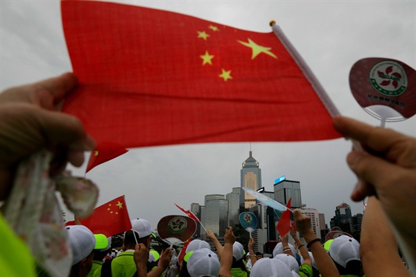Pro-China supporters wave a Chinese national flag to support police during a rally in Hong Kong, Aug. 17, 2019 (AP photo by Vincent Yu).