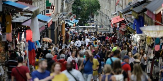 People, mainly tourists, throng a street in the Montmartre district of Paris, Aug. 9, 2019 (AP photo by Lewis Joly).