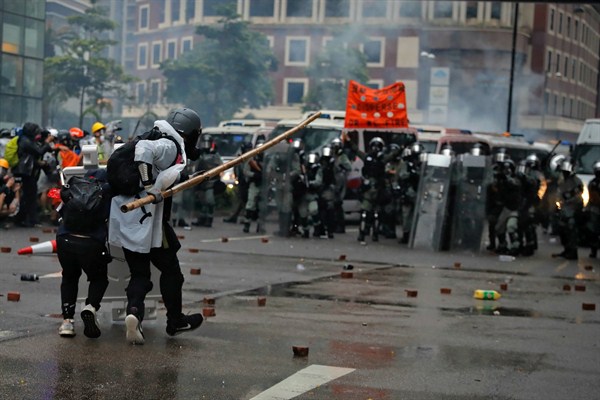 Protesters use bamboo sticks as they face riot police during a protest in Hong Kong, Aug. 25, 2019 (AP photo by Kin Cheung).