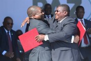 Mozambique’s president, Filipe Nyusi, right, and Renamo leader Ossufo Momade hug each other after signing a peace accord at Gorongosa National Park, Mozambique, Aug, 1, 2019 (AP photo by Tsvangirayi Mukwazhi).