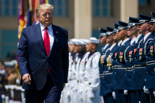 President Donald Trump reviews the troops during a full honors welcoming ceremony for Secretary of Defense Mark Esper at the Pentagon, in Washington, July 25, 2019 (AP photo by Alex Brandon).