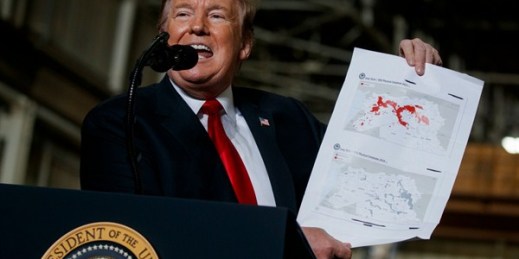 President Donald Trump holds up a chart documenting land lost by the Islamic State in Iraq and Syria as he delivers remarks in Lima, Ohio, March 20, 2019 (AP photo by Evan Vucci).