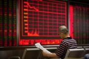 A Chinese investor monitors stock prices at a brokerage house in Beijing, Aug. 30, 2019 (AP photo by Mark Schiefelbein).