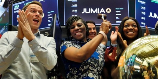 Jumia co-CEO Sacha Poignonnec, left, applauds as Jumia Nigeria CEO Juliet Anammah, center, rings a ceremonial bell on the floor of the New York Stock Exchange, April 12, 2019 (AP photo by Richard Drew).