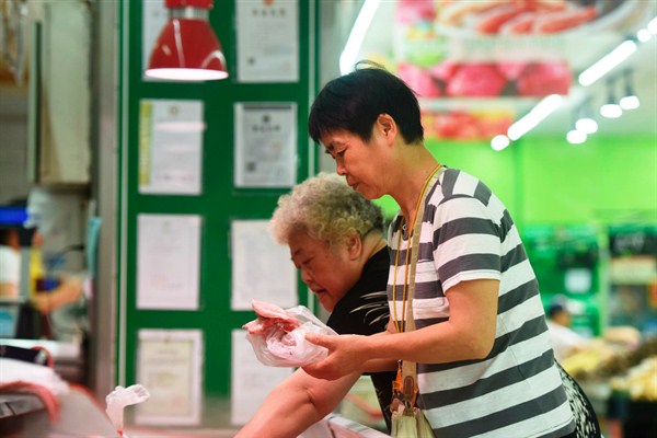 Shoppers select pork in a supermarket in Hangzhou, China, June 12, 2019 (Photo by Long Wei for FeatureChina via AP Images).