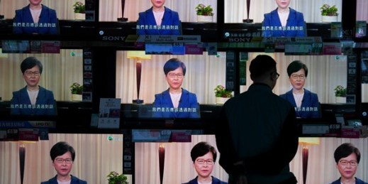 A man watches the television as Hong Kong Chief Executive Carrie Lam makes an announcement on the extradition bill, in Hong Kong, Sept. 4, 2019 (AP photo by Vincent Yu).