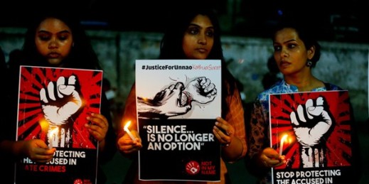 Indian women hold candles and posters during a protest against two recently reported rape cases, in Ahmadabad, India, April 16, 2018 (AP photo by Ajit Solanki).