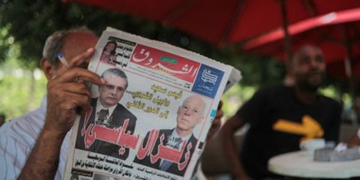 A man reads the Al-Shorouk daily newspaper showing candidates Kais Saied, right, and Nabil Karoui on its front page, a day after the first round of presidential elections, in Tunis, Tunisia, Sept. 16, 2019 (AP photo by Mosa’ab Elshamy).