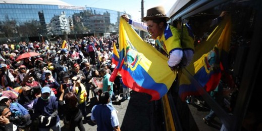 An anti-government protester waves a national flag in Quito, Ecuador, Oct. 14, 2019 (AP photo by Fernando Vergara).